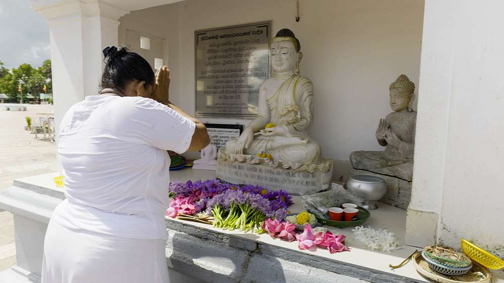 local is praying in anuradhapura temple, sri lanka
