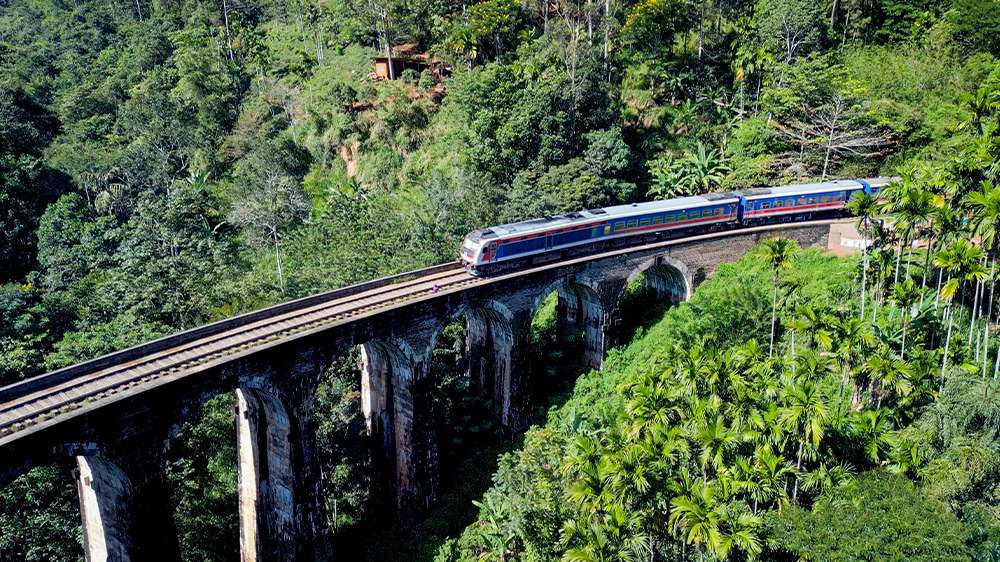 train crossing nine arches bridge in ella, sri lanka