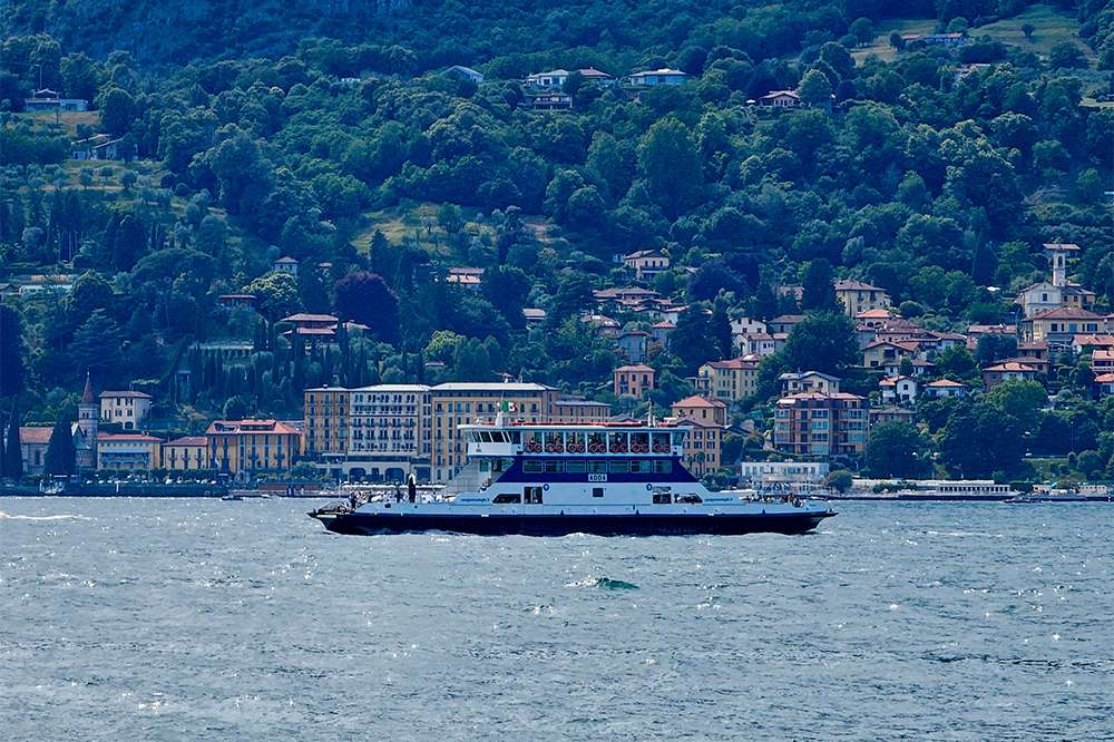 ferry is crossing lake como in italy
